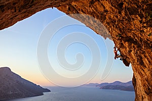 Rock climber on overhanging cliff.