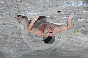 Rock climber preparing to the next move