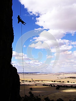 Rock climber rappelling