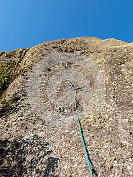 Rock climber in a rock wall seen from bellow