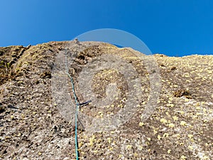 Rock climber in a rock wall seen from bellow