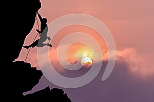 Rock climber silhouette over beautiful night sky