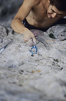 Rock Climber Struggling On Cliff