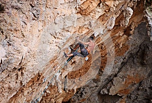 Rock climber struggling his way up