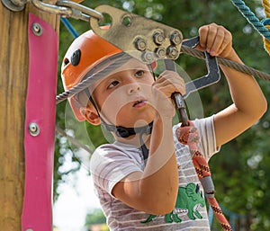 A rock climber tie a knot on a rope. A person is preparing for the ascent. The child learns to tie a knot. Checking the insurance