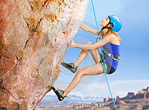 Rock climber trying to reach top of the mountains