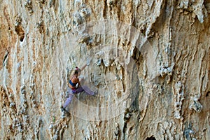 Rock climber on tufas climbing route in Kalymnos, Greece