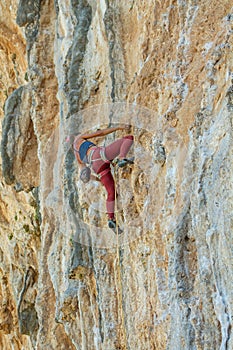 Rock climber on tufas climbing route in Kalymnos, Greece