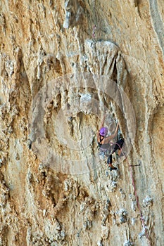 Rock climber on tufas climbing route in Kalymnos, Greece