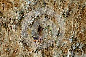 Rock climber on tufas climbing route in Kalymnos, Greece