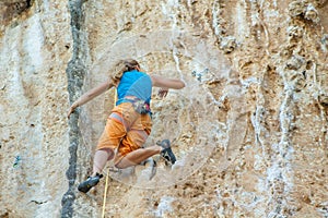 Rock climber on tufas climbing route in Kalymnos, Greece