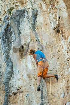 Rock climber on tufas climbing route in Kalymnos, Greece