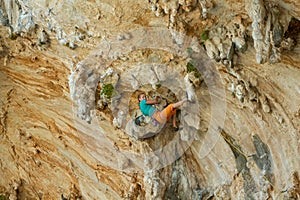 Rock climber on tufas climbing route in Kalymnos, Greece