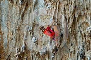 Rock climber on tufas climbing route in Kalymnos, Greece