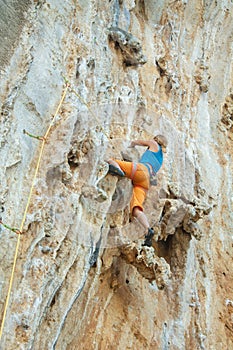 Rock climber on tufas climbing route in Kalymnos, Greece