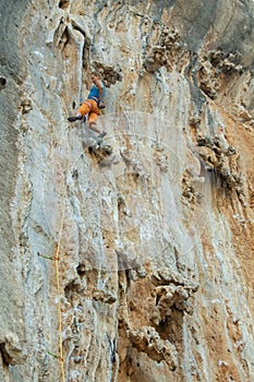 Rock climber on tufas climbing route in Kalymnos, Greece