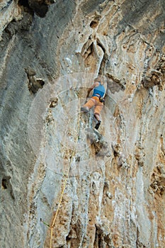 Rock climber on tufas climbing route in Kalymnos, Greece