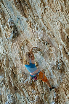 Rock climber on tufas climbing route in Kalymnos, Greece