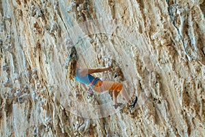 Rock climber on tufas climbing route in Kalymnos, Greece