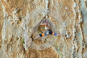 Rock climber on tufas climbing route in Kalymnos, Greece