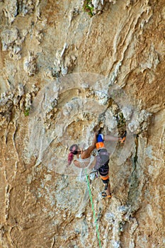 Rock climber on tufas climbing route in Kalymnos, Greece