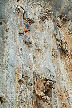 Rock climber on tufas climbing route in Kalymnos, Greece photo