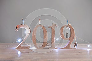 Rock climbers scaling 2019 wooden blocks