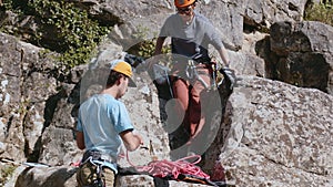 Rock Climbers Teamwork on a Sunny Day: Partners Handshake at the Summit Signifying Success, Trust, and the Bond of