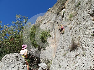 Rock climbers woman and man on the cliff