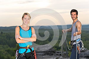 Rock climbing active people on top sunset