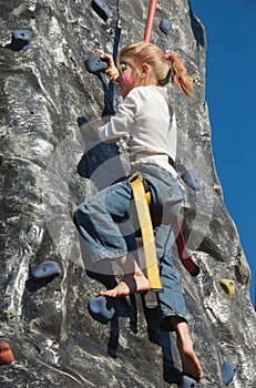 Rock climbing girl with face painting