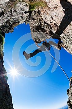 Rock climbing. Male climber on a steep rocky cliff.