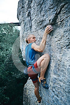 Rock climbing. man rock climber climbing the challenging route on the limestone wall