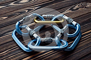 Rock climbing sports. Isolated photo of climbing equipment. Parts of carabiners lying on the wooden table