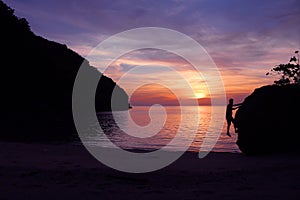 Rock climbing with sunset on the beach.