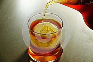 On the Rock Cold Brew Iced Coffee In A Clear glass Cup On A granite floor