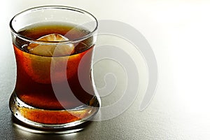 On the Rock Cold Brew Iced Coffee In A Clear glass Cup On A granite floor