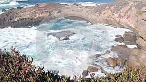 Rock crag of cliff, ocean beach, Point Lobos, California coast. Waves crashing.