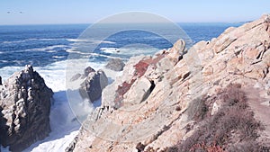 Rock crag of cliff, ocean beach, Point Lobos, California coast. Waves crashing.