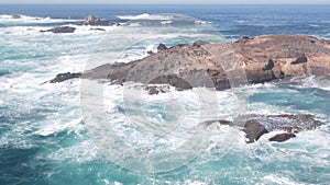 Rock crag of cliff, ocean beach, Point Lobos, California coast. Waves crashing.