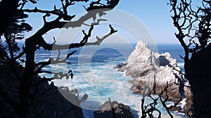 Rock crag of cliff, ocean beach, Point Lobos, California coast. Waves crashing.