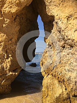 Rock crevice opening in Lagos, Portugal beach photo