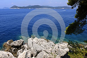 Rock in Croatia - nature travel background. clear water of the Adriatic Sea. Sanny day. Blue water