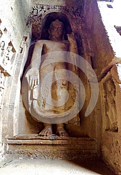 Rock cut standing Buddha statue.