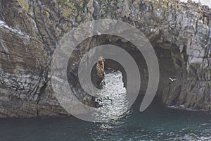 Rock drilled by the sea giving way to water