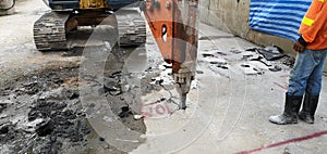 Rock drilling car working to doing the demolition concrete with worker in site at Bangkok Thailand sky train