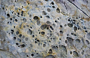 Rock erosion holes sea wall