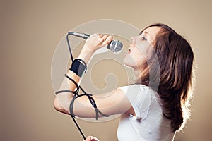 Rock female vocalist on gray background