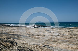 rock formation and beach with blue sky