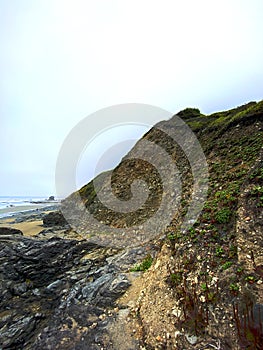 rock formation cliff cliffs ocean seaside hike nature water rain rainy fog mist background